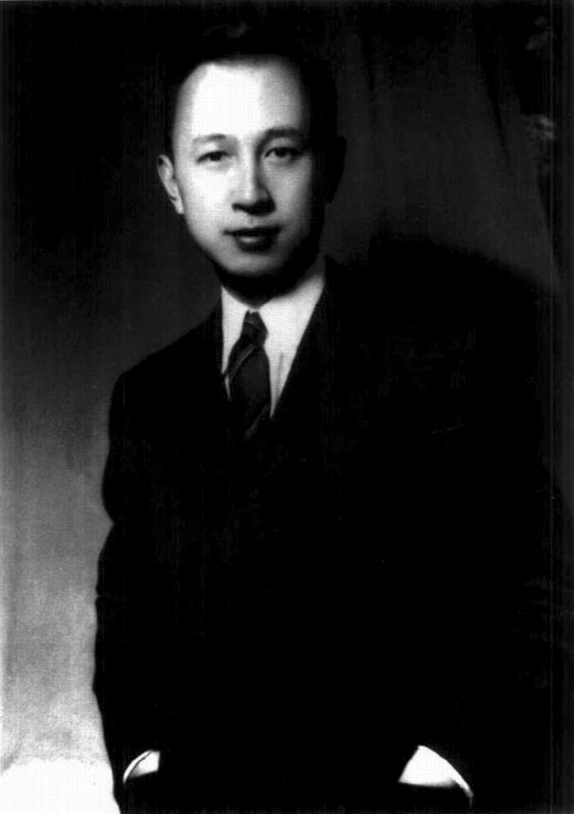 A formal black-and-white portrait of aerospace engineer Qian Xuesen in a dark suit, taken during his years in the United States.